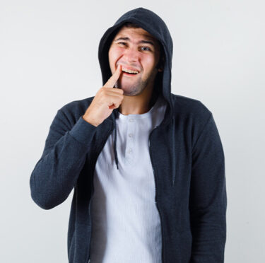 boy feeling teeth pain