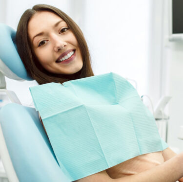 girl happy after dental implant in Clovis, CA