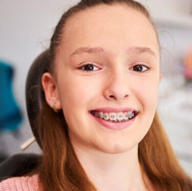 teenage girl smile with braces in teeth